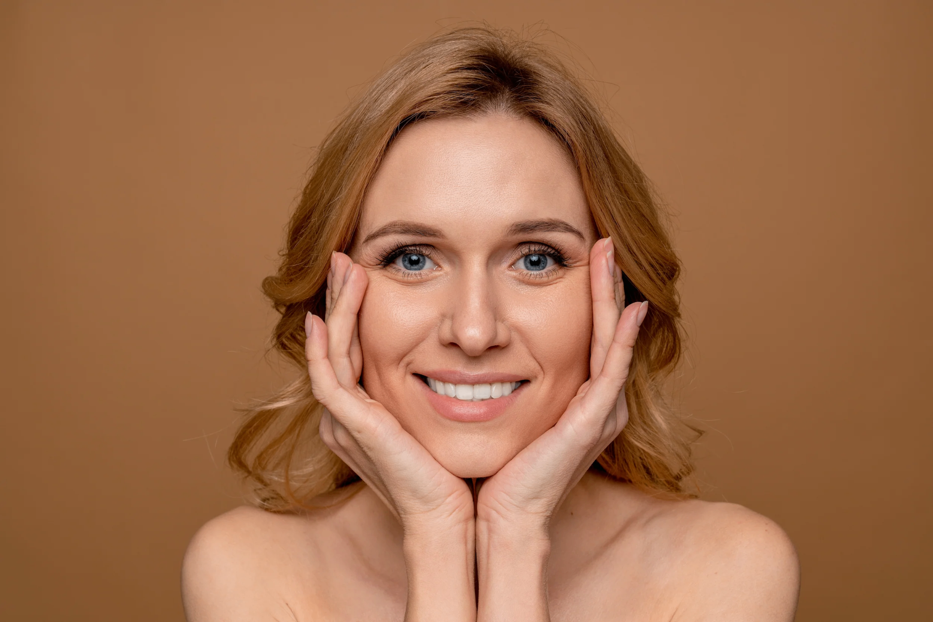 Woman with radiant skin on warm background — Hormone Replacement Therapy